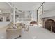 Spacious living room boasts a grand piano, fireplace, and large windows at 7624 William Penn Pl, Indianapolis, IN 46256