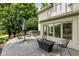Expansive patio with fire table, hot tub, seating, and lush greenery for outdoor living and entertaining at 7624 William Penn Pl, Indianapolis, IN 46256