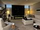 Finished basement featuring a comfortable seating area, modern fireplace, and ambient lighting at 7661 Carriage House Way, Zionsville, IN 46077