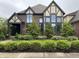 Charming two-story home with manicured lawn and beautiful garden beds at 7661 Carriage House Way, Zionsville, IN 46077