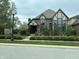 Inviting brick two-story home boasts Tudor accents, tall windows and well-manicured front lawn at 7661 Carriage House Way, Zionsville, IN 46077