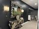 Stylish hallway showcases a decorative mirror, console table, sconces and an open view to the basement at 7661 Carriage House Way, Zionsville, IN 46077
