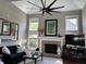 Living room with high ceilings, fireplace, and ample natural light from large windows at 7661 Carriage House Way, Zionsville, IN 46077