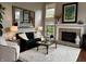Comfortable living room with fireplace, plush rug and ample natural light at 7661 Carriage House Way, Zionsville, IN 46077