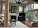 Bright living room featuring a fireplace, large windows and hardwood floors at 7661 Carriage House Way, Zionsville, IN 46077