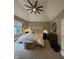 Comfortable main bedroom with neutral tones, a plush bed, and a sitting area near the window at 7661 Carriage House Way, Zionsville, IN 46077