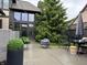 Cozy outdoor patio with stylish furniture and mature evergreen tree at 7661 Carriage House Way, Zionsville, IN 46077