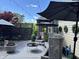 Covered patio with stylish outdoor seating, string lights, and manicured landscaping at 7661 Carriage House Way, Zionsville, IN 46077