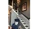 Elegant staircase with black railings and a stylish chandelier at 7661 Carriage House Way, Zionsville, IN 46077