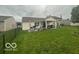 View of the backyard showing the home's patio, fenced yard, and lawn at 7733 Sergi Canyon Dr, Indianapolis, IN 46217