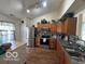 Well-lit kitchen featuring stainless steel appliances, wood cabinets, and a breakfast bar island at 7733 Sergi Canyon Dr, Indianapolis, IN 46217