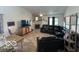Spacious living room with a fireplace, comfortable black leather seating, and hardwood-style floors at 7733 Sergi Canyon Dr, Indianapolis, IN 46217
