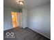 Cozy bedroom featuring neutral paint, closet, and carpeted floor at 7842 Brennan Rd, Indianapolis, IN 46219