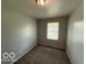 Small bedroom with one window and carpeted floor at 7842 Brennan Rd, Indianapolis, IN 46219