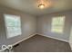 Carpeted bedroom with two windows at 7842 Brennan Rd, Indianapolis, IN 46219