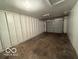 Spacious garage with ample storage space and a roll-up door at 7842 Brennan Rd, Indianapolis, IN 46219