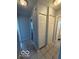 Bright hallway featuring neutral paint, tile floors, and closet at 7842 Brennan Rd, Indianapolis, IN 46219