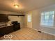 Functional kitchen with essential appliances, sleek dark cabinets, and tiled floors at 7842 Brennan Rd, Indianapolis, IN 46219