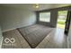 Inviting living room with neutral walls, tile flooring and a large carpeted area at 7842 Brennan Rd, Indianapolis, IN 46219