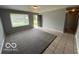 Inviting living room with neutral walls, tile flooring and a large window for natural light at 7842 Brennan Rd, Indianapolis, IN 46219