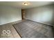 Inviting living room with neutral walls, tile flooring and a large carpeted area at 7842 Brennan Rd, Indianapolis, IN 46219