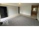 Inviting living room with neutral walls, tile flooring and a large carpeted area at 7842 Brennan Rd, Indianapolis, IN 46219