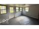 Well-lit living room with multiple windows and painted concrete flooring at 7842 Brennan Rd, Indianapolis, IN 46219