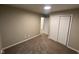 Comfortable bedroom with neutral carpet and a closet with sliding doors at 8030 Winchester Pl, Indianapolis, IN 46227