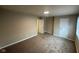 Spacious bedroom features neutral carpeting and a doorway that opens to another room at 8030 Winchester Pl, Indianapolis, IN 46227