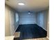 Open living room with dark wood flooring, modern ceiling fan, and stone fireplace at 8030 Winchester Pl, Indianapolis, IN 46227