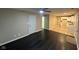 An open-concept living space with new dark flooring that connects to a bright, modern kitchen and a ceiling fan at 8030 Winchester Pl, Indianapolis, IN 46227