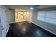 An open-concept living space with new dark flooring that connects to a bright, modern kitchen and a ceiling fan at 8030 Winchester Pl, Indianapolis, IN 46227