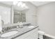 Bathroom with double sinks, granite counters, framed mirror and a glass-enclosed shower at 8266 Glacier Ridge Dr, Fishers, IN 46038