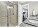 Bright bathroom featuring double sinks, a glass-enclosed shower, and seamless access to the bedroom at 8266 Glacier Ridge Dr, Fishers, IN 46038
