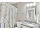 Bright bathroom featuring a granite countertop, modern vanity, and a stylish shower curtain at 8266 Glacier Ridge Dr, Fishers, IN 46038