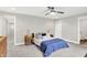 Bright bedroom featuring a modern ceiling fan, carpet flooring, and stylish matching nightstands at 8266 Glacier Ridge Dr, Fishers, IN 46038