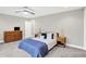 Relaxing bedroom features plush carpeting, a modern ceiling fan, and stylish, minimalist furniture at 8266 Glacier Ridge Dr, Fishers, IN 46038