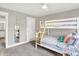 Bright bedroom featuring a charming bunk bed, mirror, and easy access to the bathroom at 8266 Glacier Ridge Dr, Fishers, IN 46038