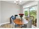 Bright dining area with a wooden table, four chairs, and sliding glass doors to the patio at 8266 Glacier Ridge Dr, Fishers, IN 46038