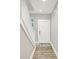 Bright entryway featuring hardwood floors, white stairs, and a door with modern hardware at 8266 Glacier Ridge Dr, Fishers, IN 46038