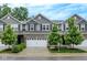 Beautiful two-story townhome with a well-manicured front yard, gray siding, and attached two-car garage at 8266 Glacier Ridge Dr, Fishers, IN 46038