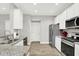 Modern kitchen features stainless steel appliances, white cabinetry, and stylish granite countertops at 8266 Glacier Ridge Dr, Fishers, IN 46038