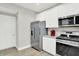 Efficient kitchen with stainless steel refrigerator, microwave, and gas range stove at 8266 Glacier Ridge Dr, Fishers, IN 46038