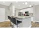Modern kitchen boasts granite counters, stainless appliances, and stylish bar stool seating at 8266 Glacier Ridge Dr, Fishers, IN 46038