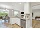 Sunlit kitchen with granite countertops, stainless steel appliances, and view of the dining area at 8266 Glacier Ridge Dr, Fishers, IN 46038