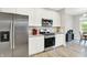 Well-appointed kitchen with stainless steel appliances, white cabinetry, and granite countertops at 8266 Glacier Ridge Dr, Fishers, IN 46038