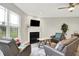Cozy living room with a fireplace, large window, and comfortable seating area at 8266 Glacier Ridge Dr, Fishers, IN 46038