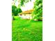 A lush backyard featuring green grass, a white fence, and a glimpse of a cozy home at 8357 Harrison Dr, Lawrence, IN 46226