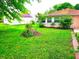 Lush backyard with green grass, plants, and a view of the house at 8357 Harrison Dr, Lawrence, IN 46226