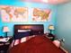 Cozy bedroom features a comfortable bed, maps, and ambient lighting at 8357 Harrison Dr, Lawrence, IN 46226